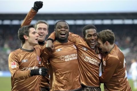 St. Pauli's  Gerald Asamoah, center, jubilates with teammates after a goal during a German Bundsliga soccer match between FC St. Pauli Hamburg and Borussia Moenchengladbach in Hamburg, northern Germany Saturday Feb. 12, 2011. (AP Photo/Dapd/Axel Heimken) NO MOBILE USE UNTIL 2 HOURS AFTER THE MATCH, WEBSITE USERS ARE OBLIGED TO COMPLY WITH DFL-RESTRICTIONS, SEE INSTRUCTIONS FOR DETAILS 