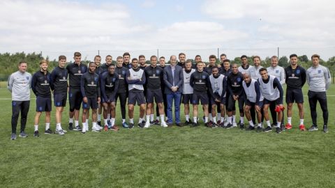 Britain's Prince William, centre, poses for a photo for with the England soccer team during his visit to the FA training ground to meet players ahead of their friendly match against Costa Rica, in Leeds, England, Thursday, June 7, 2018. (Charlotte Graham/Pool Photo via AP)