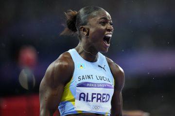 Julien Alfred, of Saint Lucia, celebrates after winning the women's 100-meter final at the 2024 Summer Olympics, Saturday, Aug. 3, 2024, in Saint-Denis, France. (AP Photo/Petr David Josek)