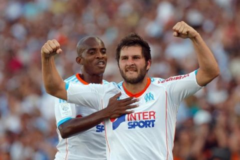 Marseille's French forward Andre-Pierre Gignac, right, reacts with Marseille's Burkinabe midfielder Charles Kabore, after scoring against Sochaux, during their League One soccer match, at the Velodrome stadium, in Marseille, southern France, Sunday, Aug. 19, 2012. (AP Photo/Claude Paris)