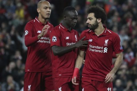 Liverpool forward Mohamed Salah, right celebrates with teammates after scoring his sides 3rd goal from the penalty spot during the Champions League group C soccer match between Liverpool and Red Star at Anfield stadium in Liverpool, England, Wednesday, Oct. 24,2018.(AP Photo/Jon Super)