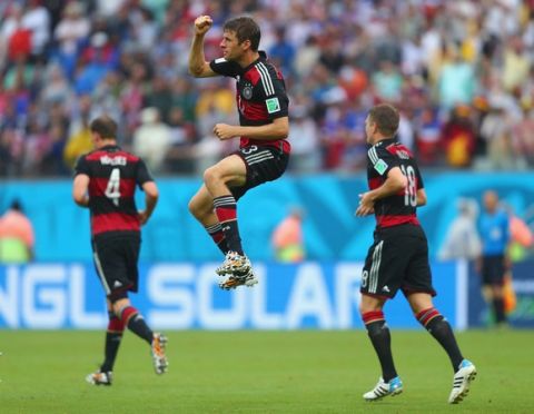 RECIFE, BRAZIL - JUNE 26:  Thomas Mueller of Germany (C) celebrates scoring his team's first goal during the 2014 FIFA World Cup Brazil group G match between the United States and Germany at Arena Pernambuco on June 26, 2014 in Recife, Brazil.  (Photo by Martin Rose/Getty Images)