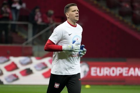 Poland's goalkeeper Wojciech Szczesny warms up for the Euro 2024 group E qualifying soccer match between Poland and Czech Republic at the National stadium in Warsaw, Poland, Friday, Nov. 17, 2023. (AP Photo/Czarek Sokolowski)