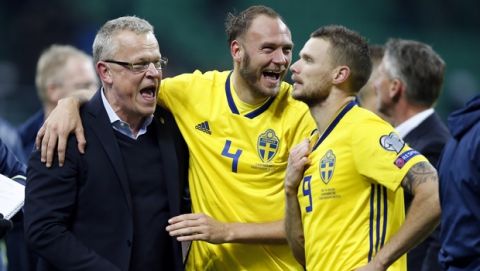 Sweden coach Janne Andersson celebrates with Andreas Granqvist and Marcus Berg, right, at the end of the World Cup qualifying play-off second leg soccer match between Italy and Sweden, at the Milan San Siro stadium, Italy, Monday, Nov. 13, 2017. Four-time champion Italy has failed to qualify for World Cup; Sweden advances with 1-0 aggregate win in playoff. (AP Photo/Antonio Calanni)