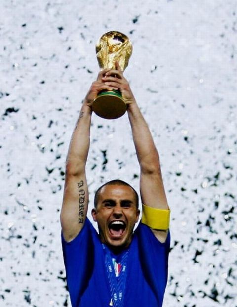 BERLIN - JULY 09: Fabio Cannavaro of Italy lifts the World Cup trophy aloft following his team's victory in a penalty shootout at the end of the FIFA World Cup Germany 2006 Final match between Italy and France at the Olympic Stadium on July 9, 2006 in Berlin, Germany.  (Photo by Shaun Botterill/Getty Images)