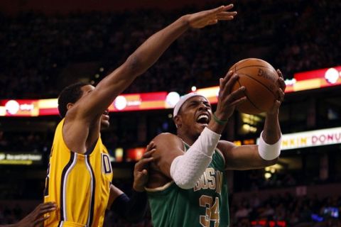 Boston Celtics forward Paul Pierce (R) drives to the basket against Indiana Pacers forward Danny Granger in the first quarter of their NBA basketball game in Boston, Massachusetts March 16, 2011.   REUTERS/Brian Snyder    (UNITED STATES - Tags: SPORT BASKETBALL)