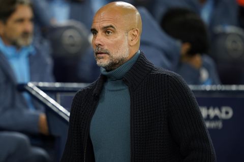 Manchester City's head coach Pep Guardiola walks before the English League Cup soccer match between Manchester City and Watford in Manchester, England, Tuesday, Sept. 24, 2024. (AP Photo/Dave Thompson)