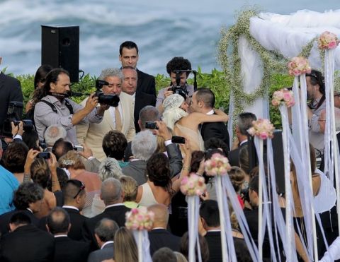 Barcelona's midfielder and player fo the Spain's national football team Andres Iniesta (C) kisses his wife during their wedding ceremony in Altafulla, near Tarragona on July 8, 2012. AFP PHOTO/ JOSEP LAGO