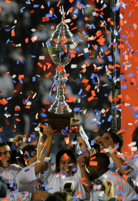 Uruguayan Nacional team player, Argentine Marcelo Gallardo (C), holds the trophy after winning the Uruguayan football tournament in his last professional match, after his team defeated Defensor at the Estadio Centenario in Montevideo on June 12,  2011. AFP PHOTO/Pablo PORCIUNCULA (Photo credit should read PABLO PORCIUNCULA/AFP/Getty Images)