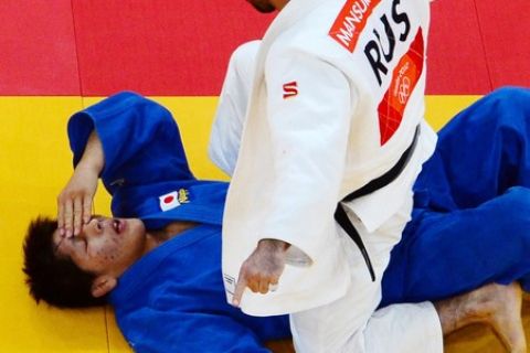 Russia's Mansur Isaev (white) celebrates winning against Japan's Riki Nakaya competes with (blue) during their men's -73kg judo contest final match of the London 2012 Olympic Games on July 30, 2012 at the ExCel arena in London. AFP PHOTO / ANTONIN THUILLIER        (Photo credit should read ANTONIN THUILLIER/AFP/GettyImages)