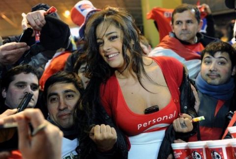 Paraguayan model Larissa Riquelme poses with supporters during a 2011 Copa America semi-final football match against Venezuela held at the Malvinas Argentinas stadium in Mendoza, 1058 Km west of Buenos Aires, on July 20, 2011.