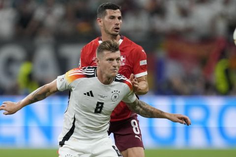 Switzerland's Remo Freuler, right, challenges Germany's Toni Kroos during a Group A match between Switzerland and Germany at the Euro 2024 soccer tournament in Frankfurt, Germany, Sunday, June 23, 2024. (AP Photo/Darko Vojinovic)