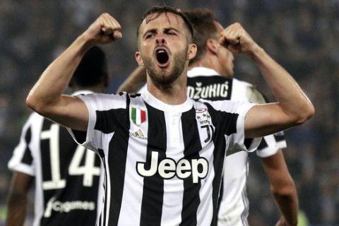 Juventus' Miralem Pjanic celebrates during the Italian Cup final soccer match between Juventus and AC Milan, at the Rome Olympic stadium, Wednesday, May 9, 2018. (AP Photo/Gregorio Borgia)