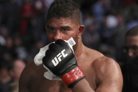 EDS NOTE-GRAPHIC CONTENT. Alistair Overeem walks back to the locker room with a cut lip after being TKOd by Jairzinho Rozenstruik in their heavyweight mixed martial arts bout at UFC Fight Night, Sunday, December 8, 2019, in Washington, D.C. Rozenstruik won via 5th round TKO. (AP Photo/Gregory Payan)