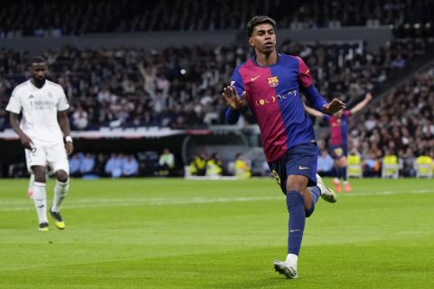 Barcelona's Lamine Yamal celebrates after scoring his side's third goal during a Spanish La Liga soccer match between Real Madrid and Barcelona at the Santiago Bernabeu stadium in Madrid, Spain, Saturday, Oct. 26, 2024. (AP Photo/Manu Fernandez)