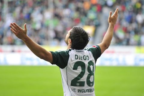 RESTRICTIONS / EMBARGO - ONLINE CLIENTS MAY USE UP TO SIX IMAGES DURING EACH MATCH WITHOUT THE AUTHORISATION OF THE DFL. NO MOBILE USE DURING THE MATCH AND FOR A FURTHER TWO HOURS AFTERWARDS IS PERMITTED WITHOUT THE AUTHORISATION OF THE DFL. Wolfsburg's Brazilian midfielder Diego celebrates after scoring the third goal during the German first division Bundesliga football match between Wolfsburg and Mainz 05 in Wolfsburg August 28, 2010. AFP PHOTO / JOHN MACDOUGALL (Photo credit should read JOHN MACDOUGALL/AFP/Getty Images)