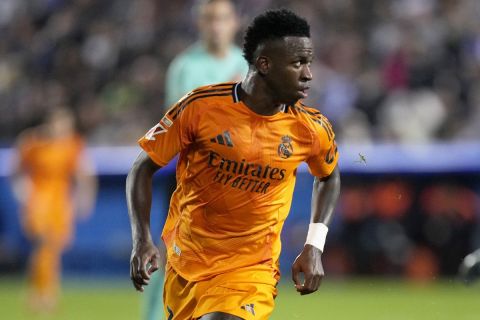 Real Madrid's Vinicius Junior runs with the ball during a Spanish La Liga soccer match between CD Leganes and Real Madrid in Leganes, outside Madrid, Sunday, Nov. 24, 2024. (AP Photo/Bernat Armangue)