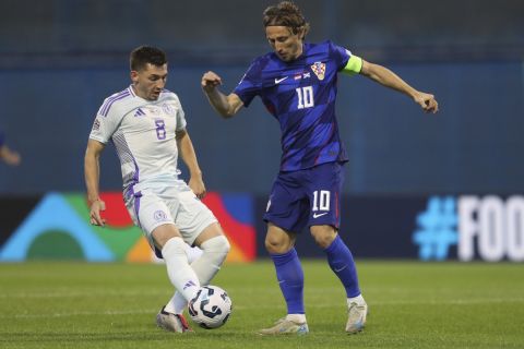 Scotland's Billy Gilmour, left, and Croatia's Luka Modric fight for the ball during the UEFA Nations League soccer match between Croatia and Scotland at Maksimir stadium in Zagreb, Croatia, Saturday, Oct. 12, 2024 (AP Photo)