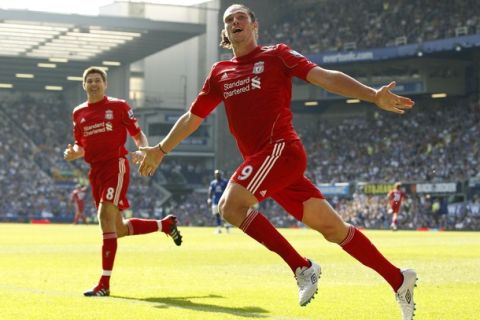 Liverpool's Andy Carroll celebrates after scoring against Everton during their English Premier League soccer match at Goodison Park in Liverpool, northern England October 1, 2011. REUTERS/Phil Noble (BRITAIN - Tags: SPORT SOCCER) FOR EDITORIAL USE ONLY. NOT FOR SALE FOR MARKETING OR ADVERTISING CAMPAIGNS. NO USE WITH UNAUTHORIZED AUDIO, VIDEO, DATA, FIXTURE LISTS, CLUB/LEAGUE LOGOS OR "LIVE" SERVICES. ONLINE IN-MATCH USE LIMITED TO 45 IMAGES, NO VIDEO EMULATION. NO USE IN BETTING, GAMES OR SINGLE CLUB/LEAGUE/PLAYER PUBLICATIONS