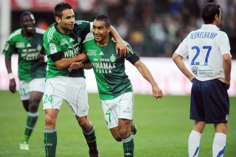 Saint Etienne French forward  Dimitri Payet (C) is congratulated by French midfielder Loic Perrin (2L) after scoring a goal after scoring a goal during the French L1 football match Saint-Etienne vs Montpellier  September 18,  2010 at the Geoffroy-Guichard stadium in Saint-Etienne.  AFP PHOTO PHILIPPE MERLE (Photo credit should read PHILIPPE MERLE/AFP/Getty Images)