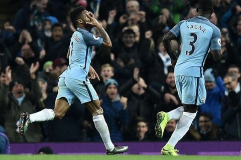 Manchester City's English midfielder Raheem Sterling (L) celebrates scoring his team's second goal during the English Premier League football match between Manchester City and Arsenal at the Etihad Stadium in Manchester, north west England, on December 18, 2016. / AFP PHOTO / Oli SCARFF / RESTRICTED TO EDITORIAL USE. No use with unauthorized audio, video, data, fixture lists, club/league logos or 'live' services. Online in-match use limited to 75 images, no video emulation. No use in betting, games or single club/league/player publications.  / OLI SCARFF/AFP/Getty Images