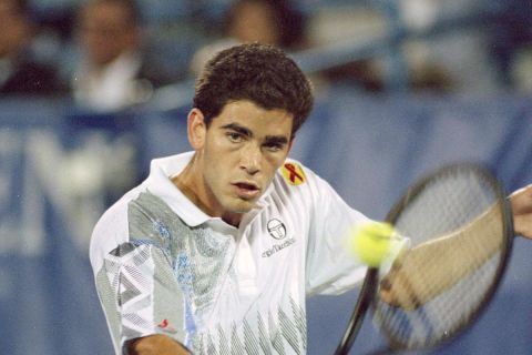 Number two seed Pete Sampras returns a shot against seventh seed Michael Chang during their match at the U.S. Open in New York, Sept. 8, 1993. (AP Photo/Mark Lennihan)