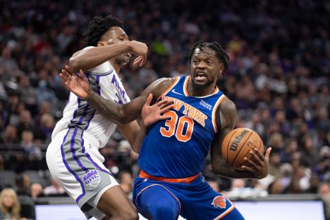 New York Knicks forward Julius Randle (30) drives to the basket while defended by Sacramento Kings Damien Jones (30) in the first quarter of an NBA basketball game in Sacramento, Calif., Monday, March 7, 2022. (AP Photo/José Luis Villegas)