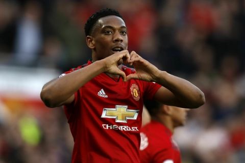 Manchester United's Anthony Martial celebrates scoring his side's second goal of the game during the English Premier League soccer match between Manchester United and Watford, at Old Trafford, in Manchester, England, Saturday March 30, 2019. (Martin Rickett/PA via AP)