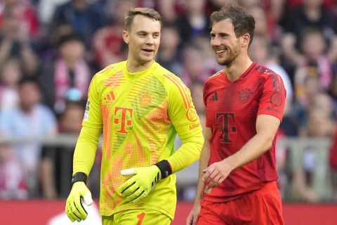 Bayern's goalkeeper Manuel Neuer, left, talks with Bayern's Leon Goretzka during the German Bundesliga soccer match between Bayern Munich and VfL Wolfsburg at the Allianz Arena in Munich, Germany, Sunday, May 12, 2024. (AP Photo/Matthias Schrader)