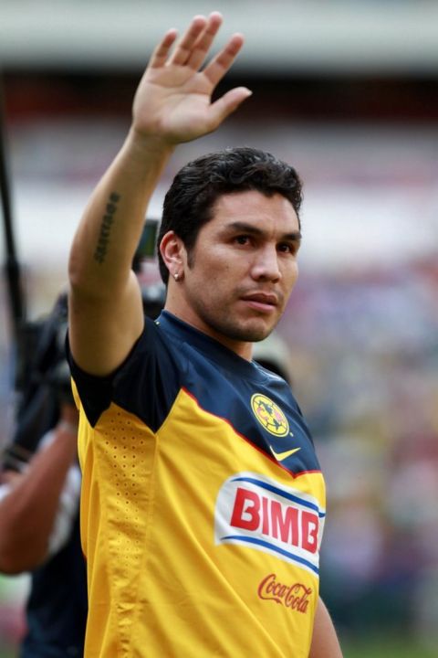 Soccer player Salvador Cabanas, playing for Mexico's America, waves to the fans during a game in his honor between Paraguay and America at the Azteca stadium in Mexico City, Wednesday Aug. 10, 2011. Cabanas was shot in the head in January 2010 in Mexico City. (AP Photo/Christian Palma)