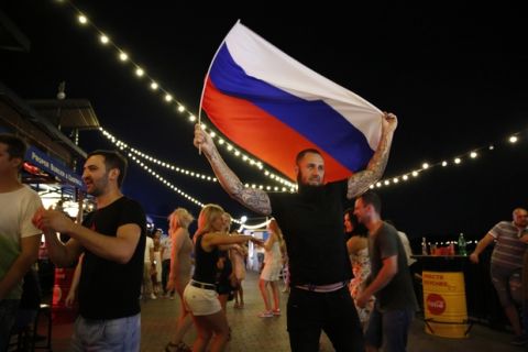 Russians dance at a bar during the 2018 soccer World Cup, on the river front in Rostov-on-Don, Russia, Saturday, June 30, 2018. (AP Photo/Rebecca Blackwell)