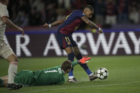 Barcelona's Raphinha takes the ball around Bayern's goalkeeper Manuel Neuer to score the opening goal during the Champions League opening phase soccer match between Barcelona and Bayern Munich at the Lluis Companys Olympic Stadium in Barcelona, Spain, Wednesday, Oct. 23, 2024. (AP Photo/Emilio Morenatti)