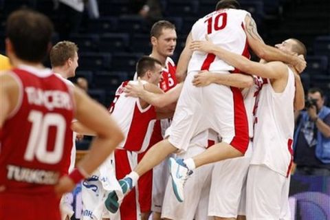 Poland players celebrate their victory in the EuroBasket, European Basketball Championship Group A match against Turkey in Panevezys, Lithuania, on Sunday, Sept.4, 2011. (AP Photo/Mindaugas Kulbis)