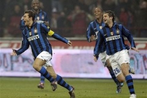 Inter Milan Argentine defender Javier Zanetti, left, celebrates after scoring as teammate Christian Chivu joins him, during an Italian major league soccer match between Inter Milan and AS Roma, at the San Siro stadium, in Milan, Italy, Wednesday, Feb.27, 2008. The match ended in a 1-1 draw. (AP Photo/Massimo Pinca)