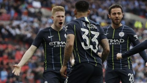 Manchester City's Gabriel Jesus celebrates with his teammates after scoring the opening goal during the English FA Cup semifinal soccer match between Manchester City and Brighton & Hove Albion at Wembley Stadium in London, Saturday, April 6, 2019. (AP Photo/Matt Dunham)