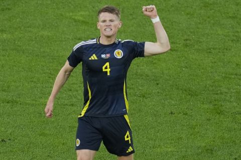 Scotland's Scott McTominay celebrates after Switzerland's Fabian Schar scored an own goal during a Group A match between Scotland and Switzerland at the Euro 2024 soccer tournament in Cologne, Germany, Wednesday, June 19, 2024. (AP Photo/Andreea Alexandru)