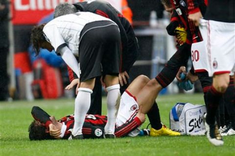 AC Milan Brazilian forward Pato lies on the ground after an injury as teammates stretch his leg during the Serie A soccer match between AC Milan and Atalanta at the San Siro stadium in Milan, Italy, Sunday, Feb. 28, 2010. (AP Photo/Antonio Calanni)