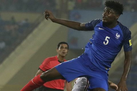 France's William Bianda in blue heads a ball during the FIFA U-17 World Cup between France and Spain in Gauhati, India, Tuesday, Oct. 17, 2017. (AP Photo/Anupam Nath)