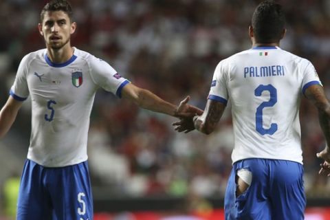 Italy's Emerson Palmieri , right, passes Jorginho as he runs to change his shorts that ripped during the UEFA Nations League soccer match between Portugal and Italy at the Luz stadium in Lisbon, Monday, Sept. 10, 2018. (AP Photo/Armando Franca)