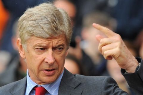 Arsenal's French manager Arsene Wenger gestures before the English Premier League football match between Blackburn Rovers and Arsenal at Ewood Park, Blackburn, north-west England on September 17, 2011. AFP PHOTO / ANDREW YATES. RESTRICTED TO EDITORIAL USE. No use with unauthorized audio, video, data, fixture lists, club/league logos or live services. Online in-match use limited to 45 images, no video emulation. No use in betting, games or single club/league/player publications. (Photo credit should read ANDREW YATES/AFP/Getty Images)