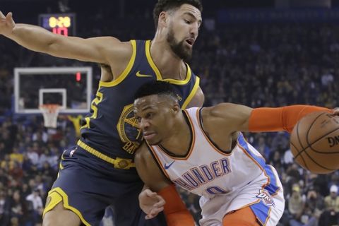 Oklahoma City Thunder guard Russell Westbrook, right, dribbles next to Golden State Warriors guard Klay Thompson during the first half of an NBA basketball game in Oakland, Calif., Wednesday, Nov. 21, 2018. (AP Photo/Jeff Chiu)