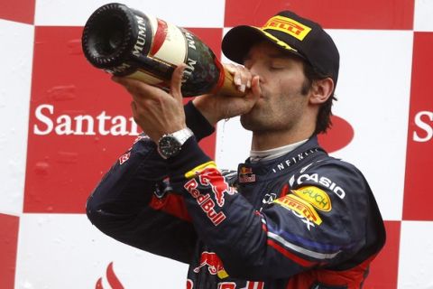 Red Bull Formula One driver Mark Webber of Australia drinks some champagne after taking the third place at the German F1 Grand Prix at the Nuerburgring circuit July 24, 2011. McLaren Formula one driver Lewis Hamilton of Britain won the race ahead of Ferrari's Fernando Alonso of Spain and Webber.   REUTERS/Kai Pfaffenbach (GERMANY - Tags: SPORT MOTOR RACING)