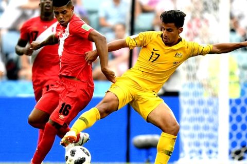 Peru's Christian Ramos, left, and Australia's Daniel Arzani challenge for the ball during the group C match between Australia and Peru, at the 2018 soccer World Cup in the Fisht Stadium in Sochi, Russia, Tuesday, June 26, 2018. (AP Photo/Martin Meissner)