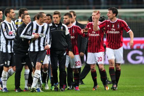 Juventus' defender Giorgio Chiellini (L) talks with AC Milan's Dutch defender Mark Van Bommel (R) on February 25, 2012 during a Serie A football match at the San Siro stadium in Milan. AFP PHOTO / GIUSEPPE CACACE (Photo credit should read GIUSEPPE CACACE/AFP/Getty Images)