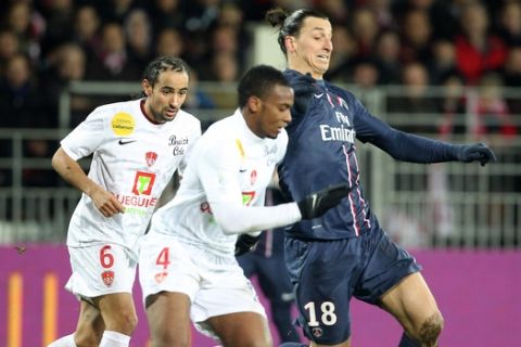 Swedish forward Zlatan Ibrahimovic of Paris Saint Germain, right, challenges for the ball with Brest's Johan Martial, center, during their French League One soccer match, in Brest, western France, Friday, Dec. 21, 2012. (AP Photo/Pierre Minier)