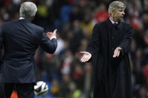 Arsenal's manager Arsene Wenger, right, is seen alongside Manchester City's  manager Mark Hughes during their English League Cup soccer match at The City of Manchester Stadium, Manchester, England, Wednesday Dec. 2, 2009. (AP Photo/Jon Super) ** NO INTERNET/MOBILE USAGE WITHOUT FOOTBALL ASSOCIATION PREMIER LEAGUE (FAPL) LICENCE. CALL +44 (0) 20 7864 9121 or EMAIL info@football-dataco.com FOR DETAILS **