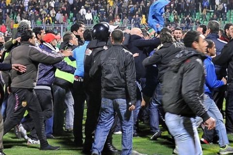 Egyptian football fans rush to the pit during riots that erupted after a football match between Al-Masry and Al-Ahly teams in Port Said, 220 kms northeast of Cairo, on February 1, 2012. At least 73 people were killed and hundreds injured in the violence that erupted as soon as the referee blew the final whistle in the match. AFP PHOTO/STR (Photo credit should read -/AFP/Getty Images)