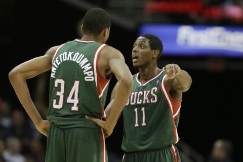 Milwaukee Bucks' Brandon Knight (11) talks to Giannis Antetokounmpo (34) during the third quarter of an NBA basketball game against the Cleveland Cavaliers Friday, Dec. 20, 2013, in Cleveland. (AP Photo/Mark Duncan)