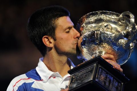 Novak Djokovic of Serbia kisses the winner's trophy after beating Andy Murray of Britain in their men's singles final on the fourteenth day of the Australian Open tennis tournament in Melbourne on January 30, 2011.  Djokovic won 6-4, 6-2, 6-3.  MAGE STRICTLY RESTRICTED TO EDITORIAL USE  STRICTLY NO COMMERCIAL USE   AFP PHOTO / GREG WOOD (Photo credit should read GREG WOOD/AFP/Getty Images)