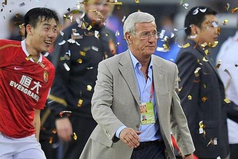 Guangzhou Evergrande coach Marcello Lippi (C) reacts after the Chinese FA Cup final football match against Guizhou Renhe in Tianhe Stadium, Guangzhou, southern China's Guangdong province on November 18, 2012.  Marcello Lippi completed a league and cup double after Guangzhou Evergrande beat Guizhou Renhe4-2 to win the Chinese FA Cup.  AFP PHOTO
